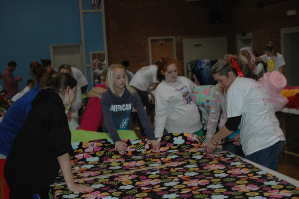 Students of a local middle school make blankets for “Covers for Cancer” to go in the “Boxes of Love”.