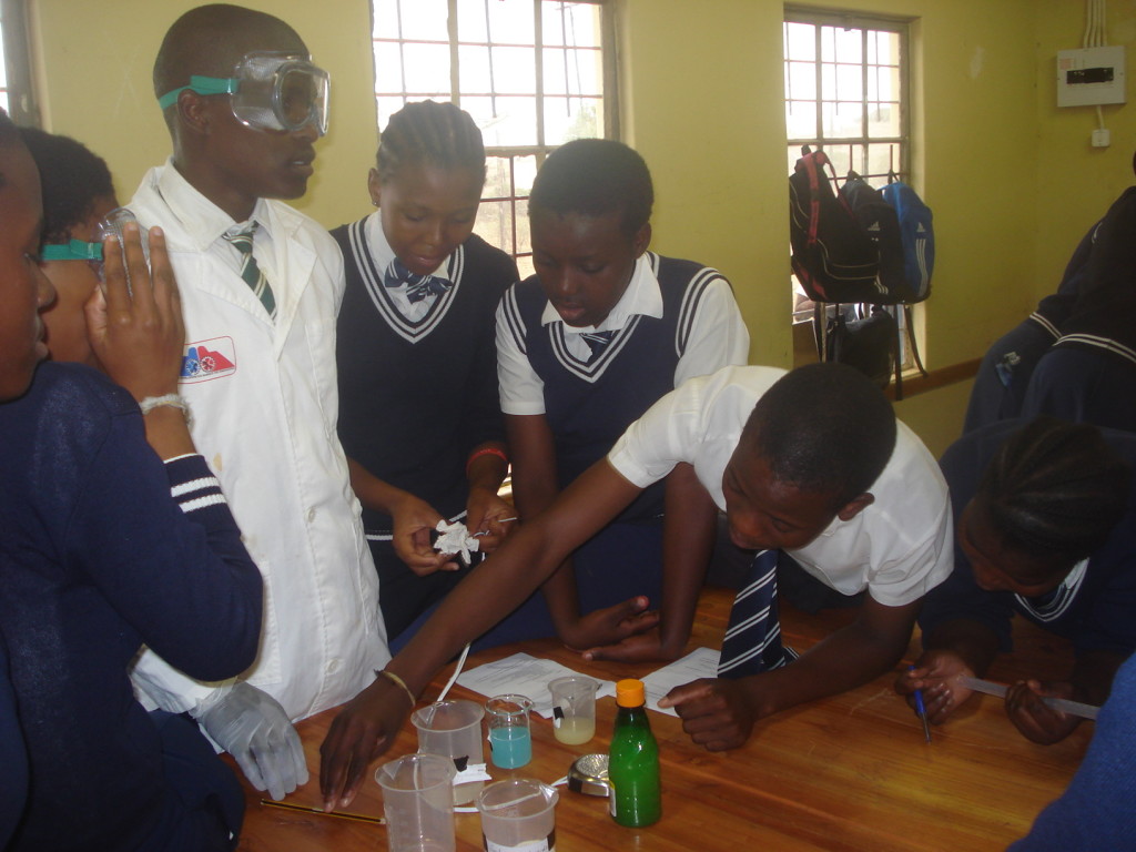 Khethelo conducting science experiments with students