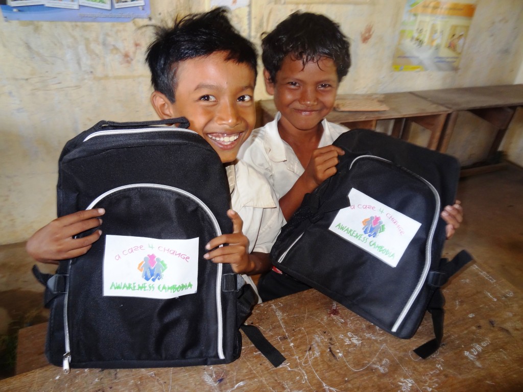 Local primary school students receiving school supplies, through the Case for Change program. Photo credit: Awareness Cambodia.