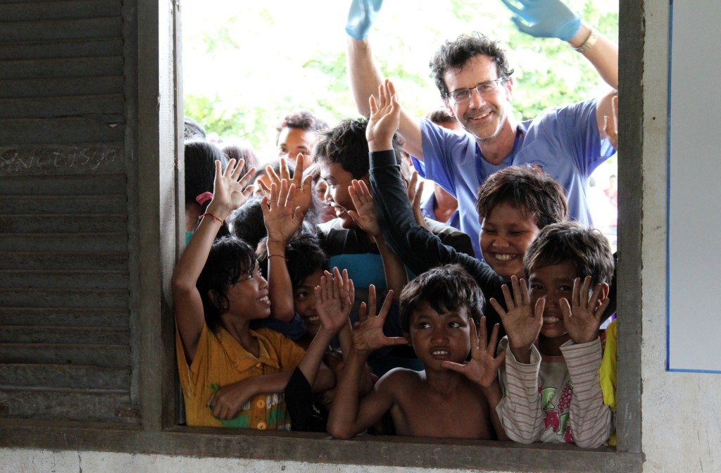 Operation Nightingale volunteer doctor with Cambodian children at mobile clinic. Photo credit: Paul Pichugin photography.