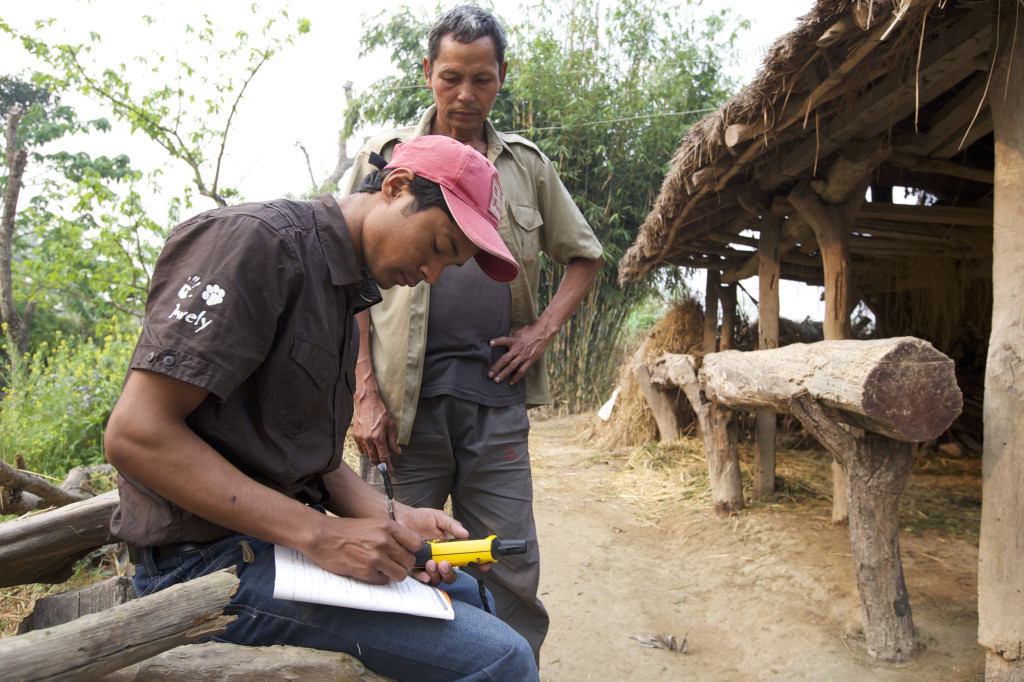 One of our Red Caps in Nepal talking to a villager who lost a goat, which was eaten by a leopard ©Awely