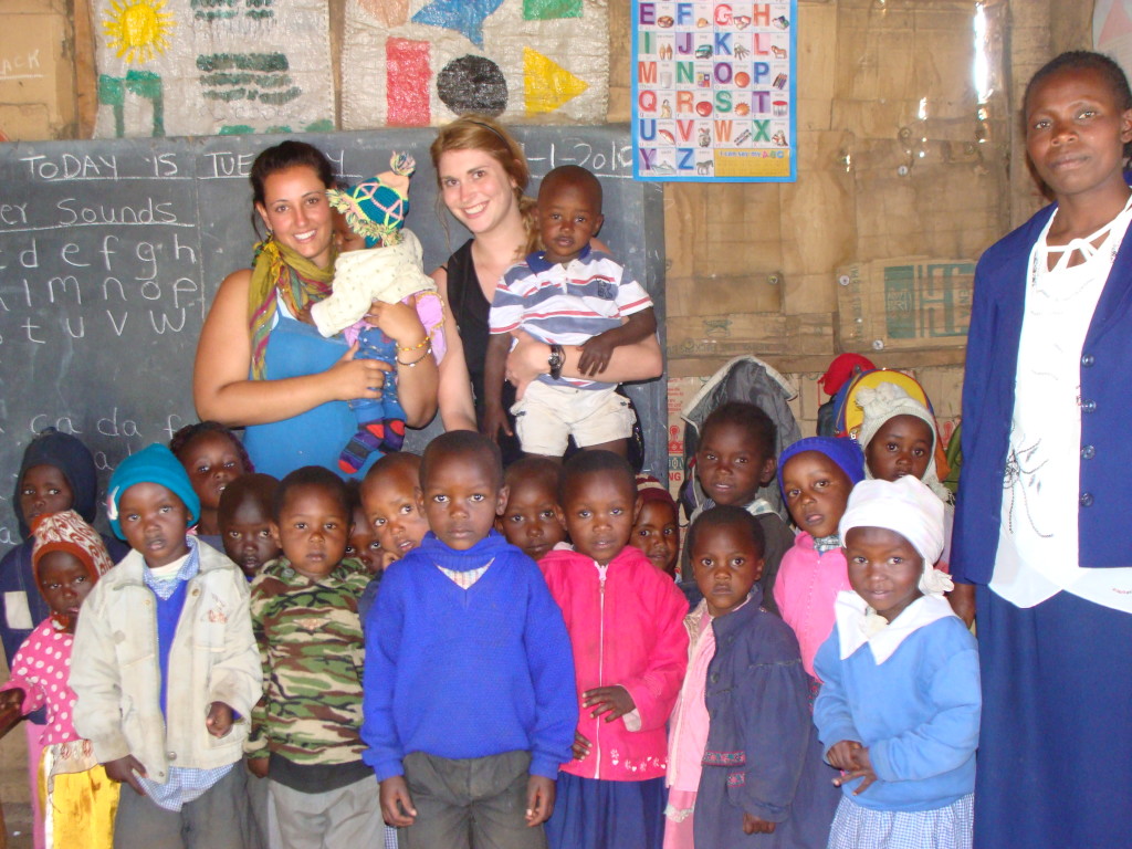 Genna with the kindergarten students in their orginal little wooden shack.